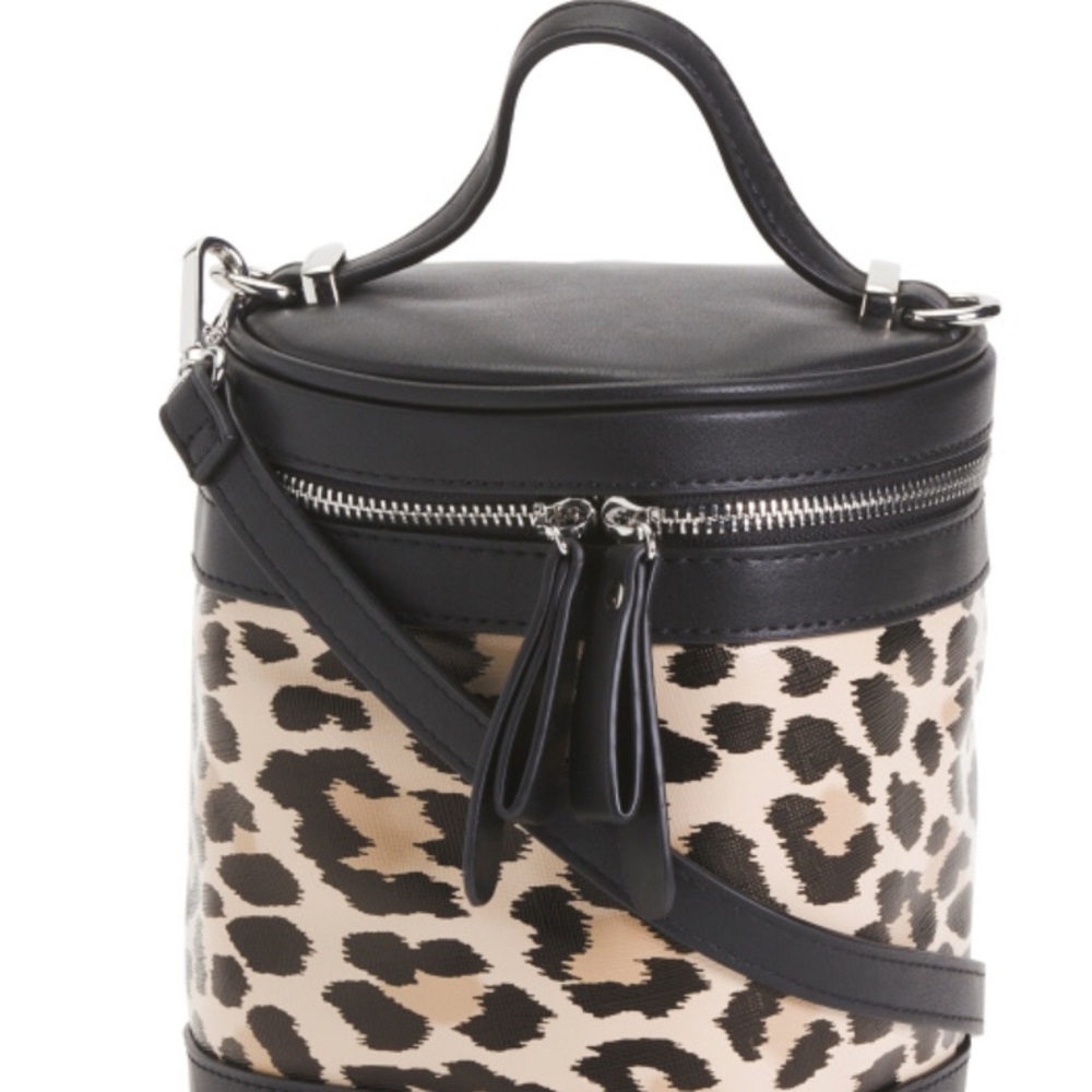 Faux leather barrel crossbody bag.